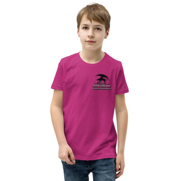 A young person wearing a pink shirt and jeans.