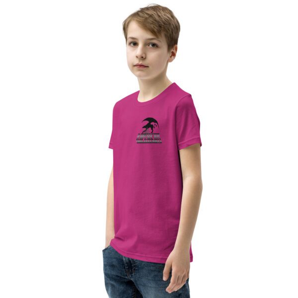 A young person wearing a pink shirt and jeans.