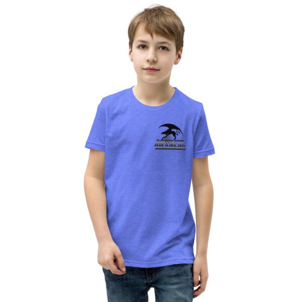 A boy wearing a blue t-shirt with an eagle on it.