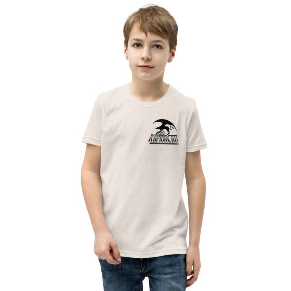 A boy wearing a white t-shirt with an eagle logo.