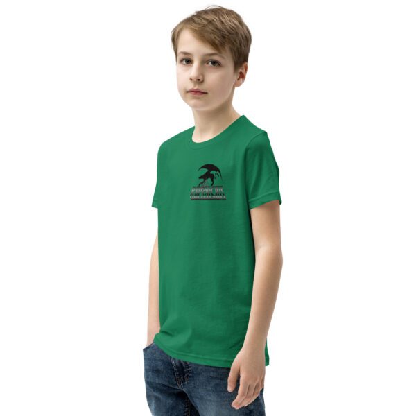 A boy wearing a green shirt and jeans.