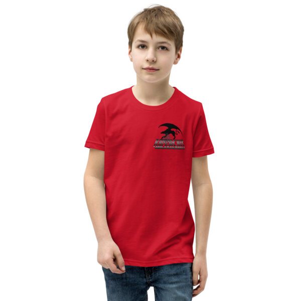 A boy wearing a red shirt and jeans.