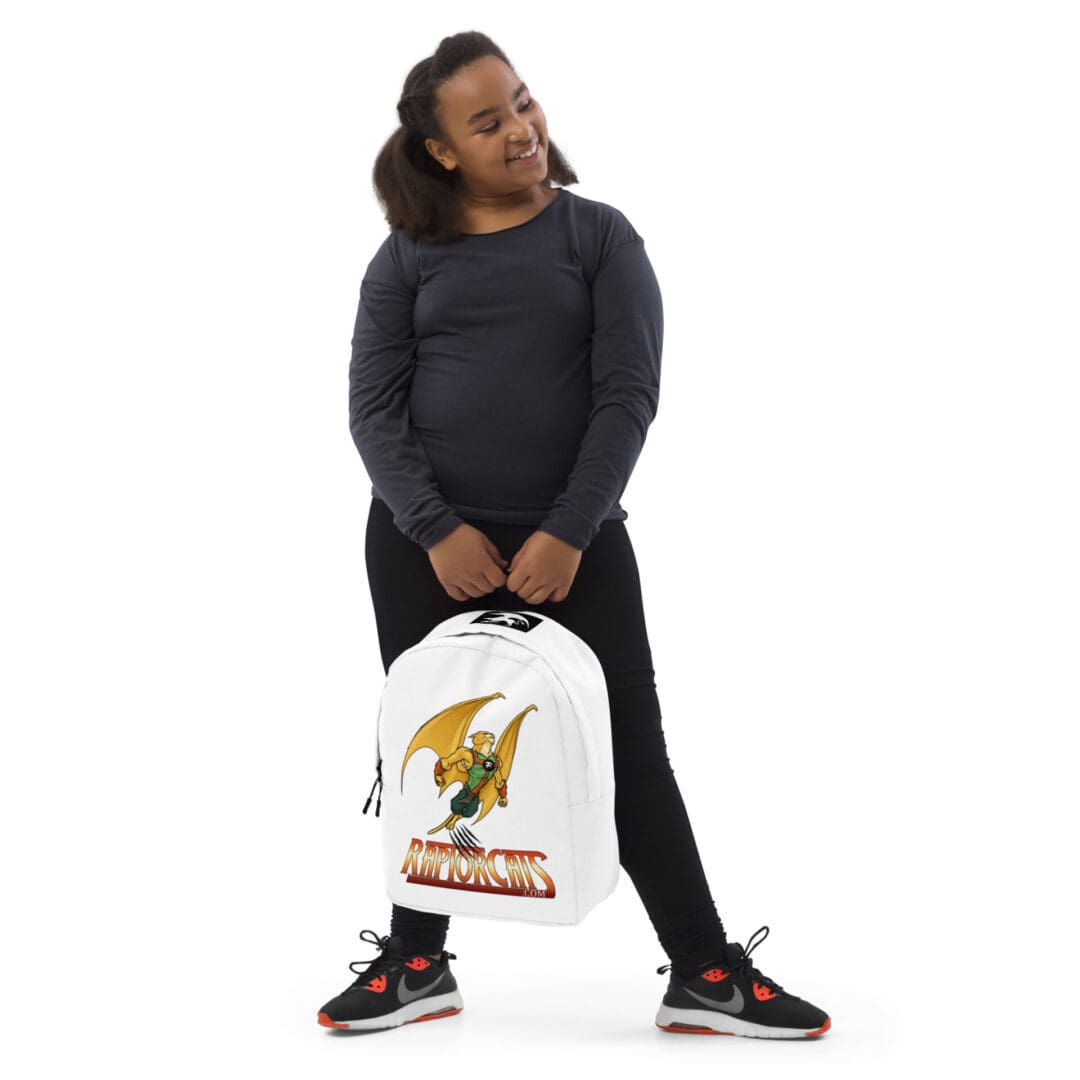 Girl smiling, holding white backpack, standing.