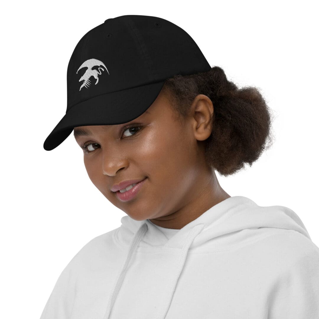 Girl wearing a black hat and hoodie.