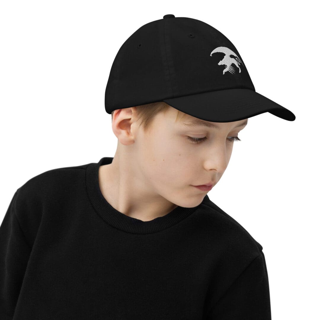 Child wearing a black cap and sweater.