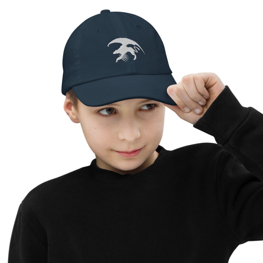 Child wearing blue hat with animal logo.