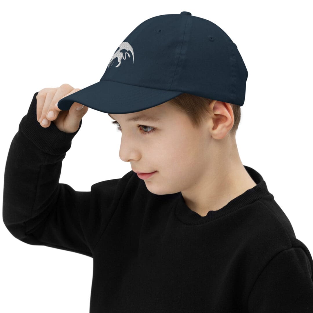 Boy wearing a blue cap and sweater.