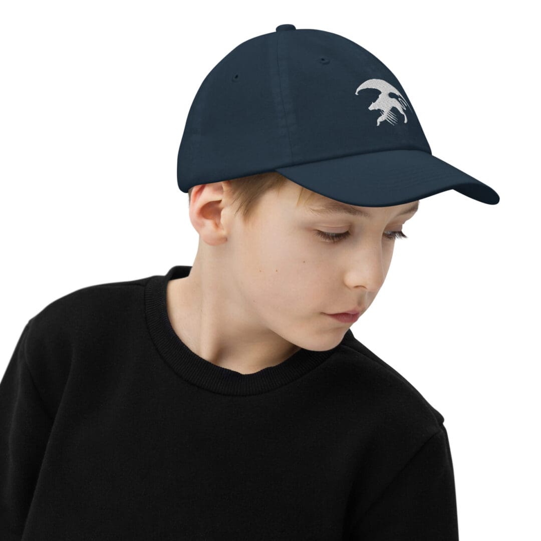 Child wearing a black cap and sweater.