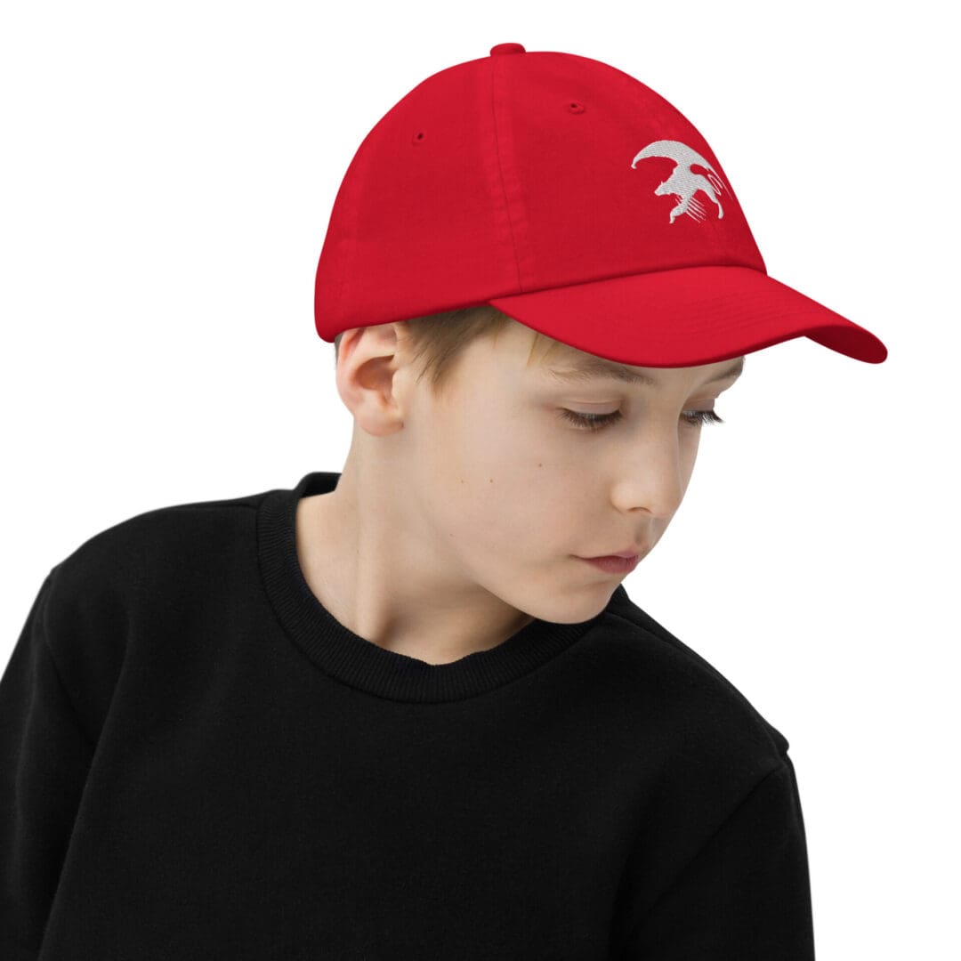 Child wearing red cap and black shirt.