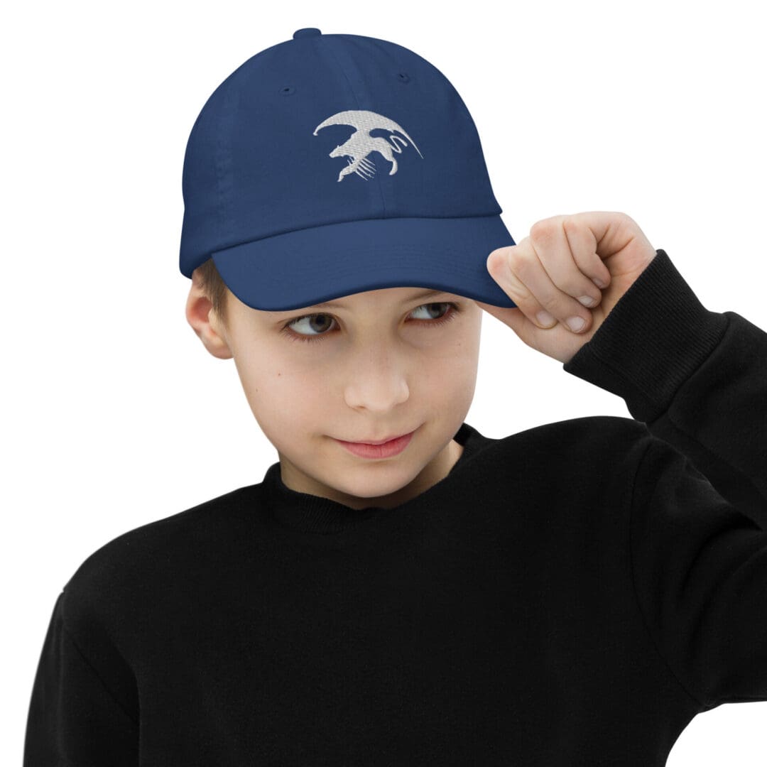 Boy wearing blue cap with logo.